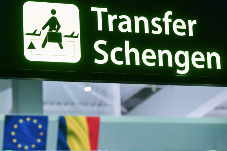 d8a8d98ad8a8-1726982945 A newly installed sign pointing to Schengen transfer flights is pictured next to EU and Romanian flags, after Romania's official entry into the European area of free circulation at Otopeni's "Henri Coanda" international airport on March 31, 2024. - Bulgaria and Romania joined Europe's vast Schengen area of free movement on March 31, opening up travel by air and sea without border checks after a 13-year wait. A veto by Austria however means the new status will not apply to land routes, after Vienna expressed concerns over a potential influx of asylum seekers. Despite the partial membership, the lifting of controls at the two countries' air and sea borders is of significant symbolic value. (Photo by Daniel MIHAILESCU / AFP)