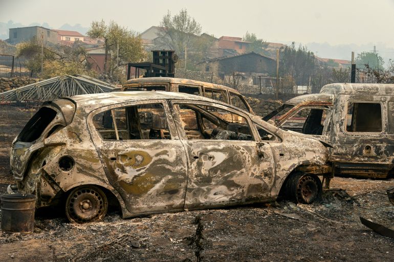 epa_6a678ca06dff-1785171104 epa13135620 Burnt cars at the village of Casavieja, Avila, Spain, 27 July 2026. In Avila's region, 15 villages have been evacuated due to the fire. Multiple fires in Spain have forced the evacuation of about 115,000 people from the affected villages. EPA/RAUL SANCHIDRIAN