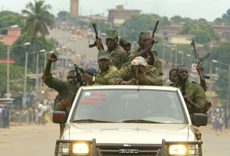 getty_693fc9b31f-1765788083 BOUAKE, IVORY COAST - OCTOBER 17: Rebel fighters patrol the streets October 17, 2002 in Bouake, Ivory Coast. The rebels, who control the northern half of the Ivory Coast, signed a cessation of hostilities document marking an important first step towards the return of peace to the Ivory Coast, according to the Executive Secretary of West African contact group, Ecowas, Dr. Mohamed Ibn Chambas. The truce is aimed at ending the month-long crisis that began with a coup attempt September 19, 2002, leaving hundreds dead. (Photo by Pascal Le Segretain/Getty Images)