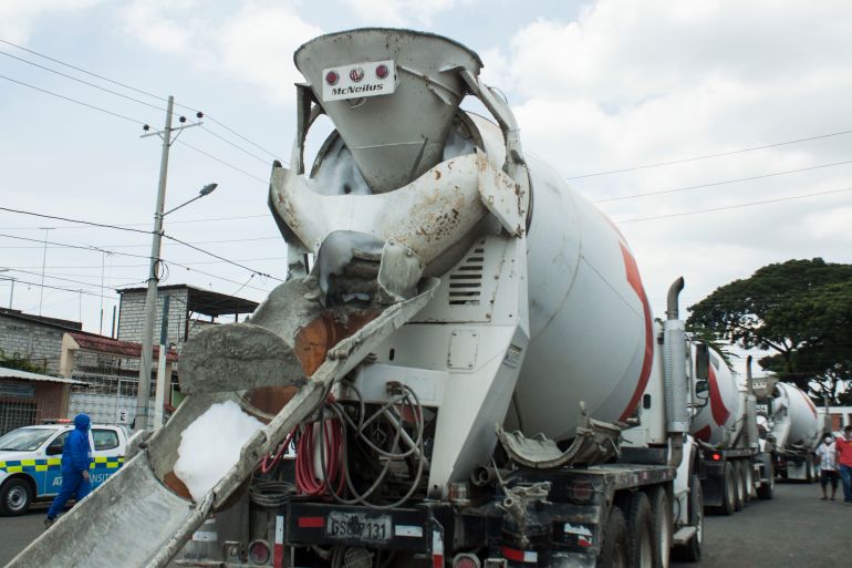 GUAYAQUIL, ECUADOR - APRIL 10: Concrete mixer trucks arrive for disinfection to carry out cleaning work due to the complaints of residents of Pascuales of strong smells that come from the cemetery on April 10, 2020 in Pascuales, Guayaquil, Ecuador. Guayas Province and its capital Guayaquil are the epicenter of the COVID-19 pandemic in Ecuador, the worst-hit per capita country in South America. Morgues and hospitals are overcrowded and government started burials in common graves in the boroughs of Pascuales and La Aurora. Number of deaths is expected to be much higher as most victims were not tested nor diagnosed. (Photo by Eduardo Maquilon/Getty Images)