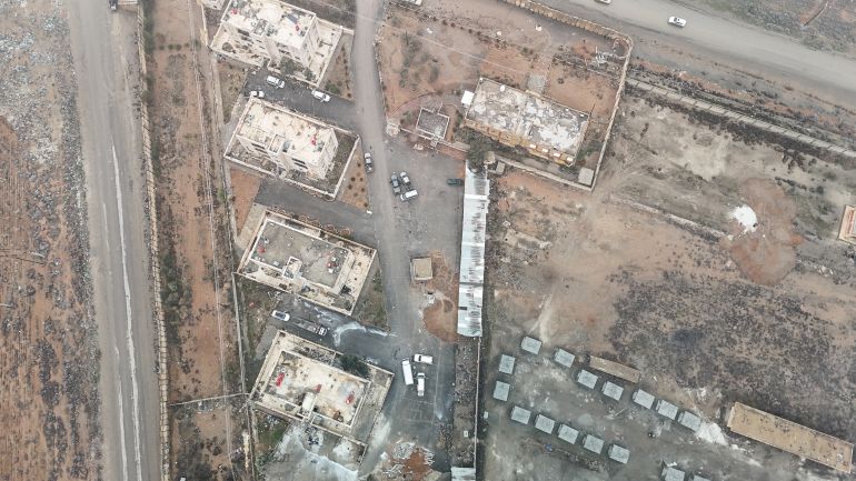 getty_6a5b7c289b-1784380456 RAQQA, SYRIA - JANUARY 23: An aerial view as members of Syrian government takeover the Al-Aqtan prison after Kurdish-led Syrian Democratic Forces (SDF) forces withdraw from al-Aqtan prison, bound for Kobani, on the outskirts of the northeastern Syrian city of Raqqa on January 23, 2026. Syrian government forces continue to retake large parts of northern and eastern Syria from Kurdish forces in a rapid push that has brought nearly all of Syria under the control of Damascus and government forces. the United States said it launched an operation Wednesday that could move thousands of Islamic State group jihadists from Syria to Iraq. (Photo by Abdulmonam Eassa/Getty Images)