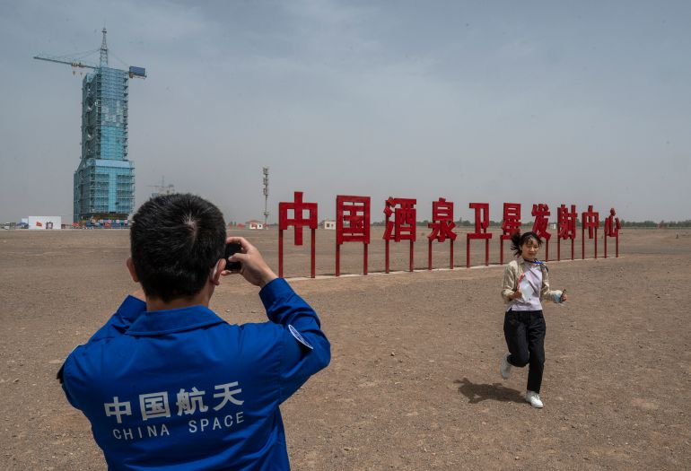 getty_6a631be906-1784880105 JIUQUAN, CHINA - MAY 29: An employee of the China Manned Space Agency takes photos at the launch site of the Shenzhou-16 and Long March-2F rocket at the Jiuquan Satellite Launch Center on May 29, 2023 in Jiuquan, China. The astronauts will travel on the Shenzhou-16 spacecraft carried by a Long March-2F rocket to Chinas Tiangong Space Station from the Gobi Desert on May 30 and will stay for six months, relieving the crew that arrived there late in 2022. (Photo by Kevin Frayer/Getty Images)