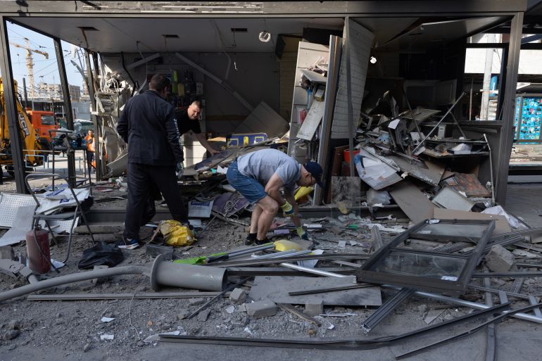 getty_6a64ca749d-1784990324 KYIV, UKRAINE - JULY 19: People clean up their small shop after a large-scale attack overnight that left at least one person dead and thirteen injured on July 19, 2026 in Kyiv, Ukraine. Kyiv was hit with about 40 Iskander-M and hypersonic Zircon missiles. (Photo by Paula Bronstein/Getty Images)