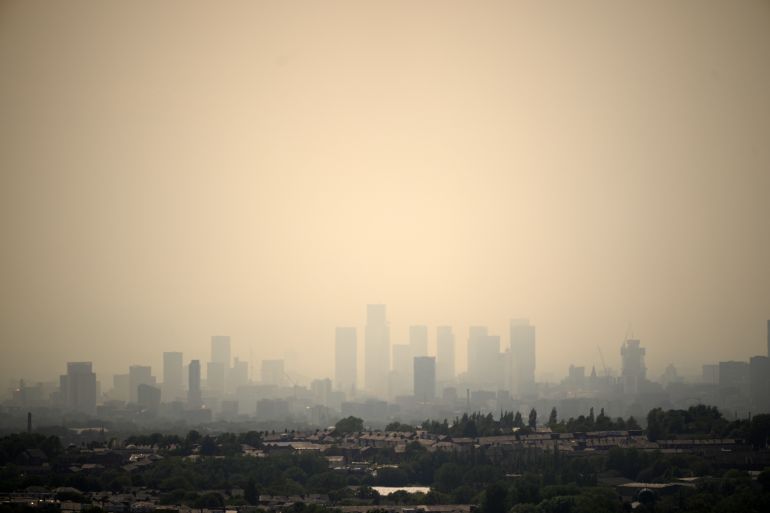 OLDHAM, ENGLAND - JULY 13: Seen from Oldham, a veil of smoke from the Peak District wildfires hangs over the Manchester City skyline on July 13, 2026 in Oldham, England. A major incident has been declared on between Tintwistle Moor in Glossop, Derbyshire and Dovecote Reservoir as high winds and a severe heatwave caused a wildfire, which originally broke out on 24 June, to flare up. (Photo by Christopher Furlong/Getty Images)