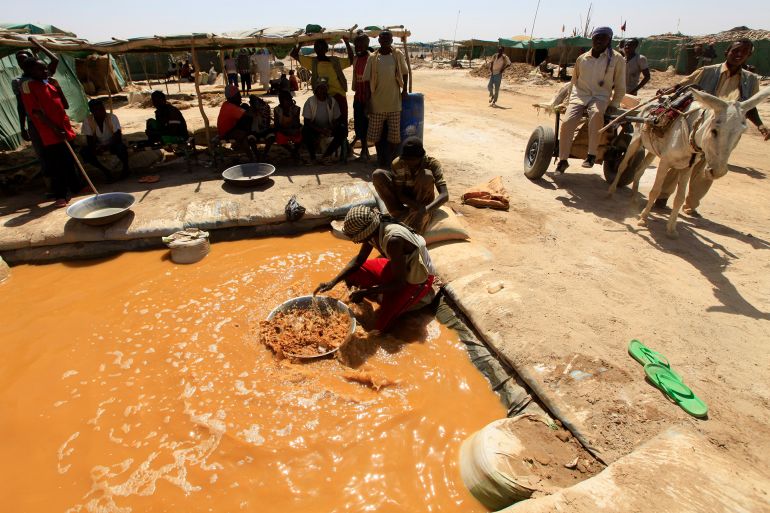 mine-2-1783363055 A worker pans for gold at the Wad Bushara gold mine near Abu Delelq in Gadarif State, Wad Bushara April 27, 2013. Sudan exported $2.2 billion worth of gold last year and hopes to produce around 50 tonnes of gold in 2013, which would potentially make it Africa's third-largest gold miner and push it into the top 15 producers globally. The Wad Bushara gold mine has about 2,000 workers who earn an average of $15 a day. Picture taken April 27. REUTERS/Mohamed Nureldin Abdallah (SUDAN - Tags: BUSINESS EMPLOYMENT COMMODITIES)