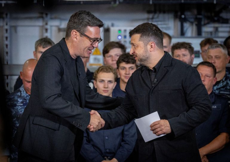 British Prime Minister Andy Burnham interacts with the President of Ukraine, Volodymyr Zelenskiy, during their visit to Portsmouth Naval Base to meet UK and Ukrainian troops, July 27, 2026. Simon Jones/Pool via REUTERS