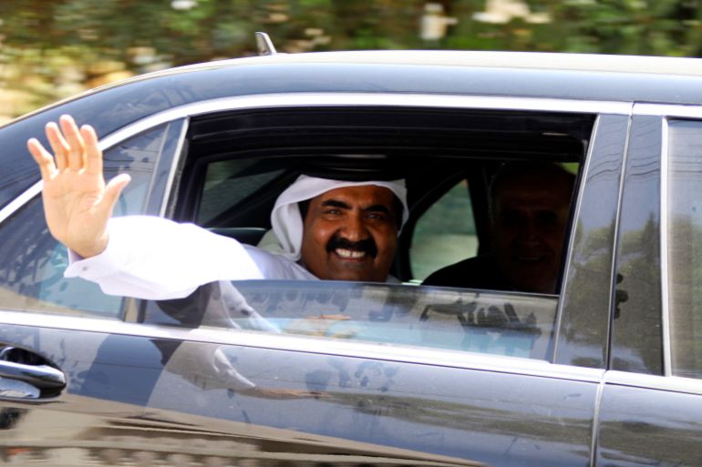 Emir of Qatar Sheikh Hamad bin Khalifa al-Thani, accompanied by Lebanon's President Michel Suleiman, waves his hand upon his arrival to tour Bint Jbeil, southern Lebanon, July 31, 2010. Qatari Emir Sheikh Hamad bin Khalifa al-Thani toured Bint Jbeil and other southern Lebanese villages badly destroyed during the 2006 Hezbollah-Israeli war which Qatar later helped rebuild by donating extensive funds. REUTERS/Ali Hashisho (LEBANON - Tags: POLITICS ROYALS)