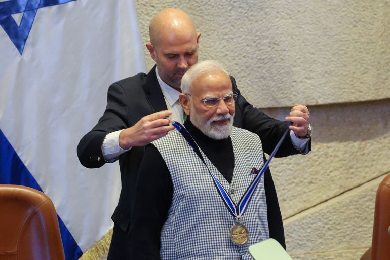 pic-998844-1783609248-1 Speaker of the Knesset Amir Ohana awards a 'Knesset Medal' to India's Prime Minister Narendra Modi, during a special session of the Knesset, Israel's parliament, in Jerusalem, February 25, 2026. REUTERS/Ronen Zvulun
