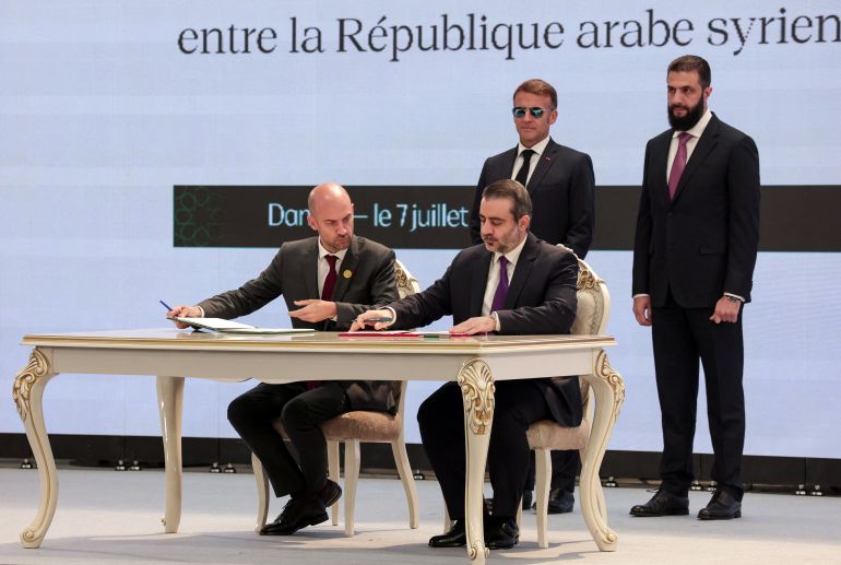reuters_6a4e22e7-1783505639 Syria's Foreign Minister Asaad Hassan Al-Shaibani and France's Foreign Minister Jean-Noel Barrot sign documents next to France's President Emmanuel Macron and Syrian President Ahmed Al-Sharaa, at a ceremony in Damascus, Syria, July 7, 2026. REUTERS/Mahmoud Hassano
