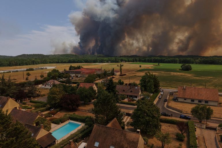 A drone view from Milly-la-Foret shows smoke rising from a wildfire the Fontainebleau forest near Paris during a heatwave affecting large parts of France, July 13, 2026. REUTERS/Stephane Mahe