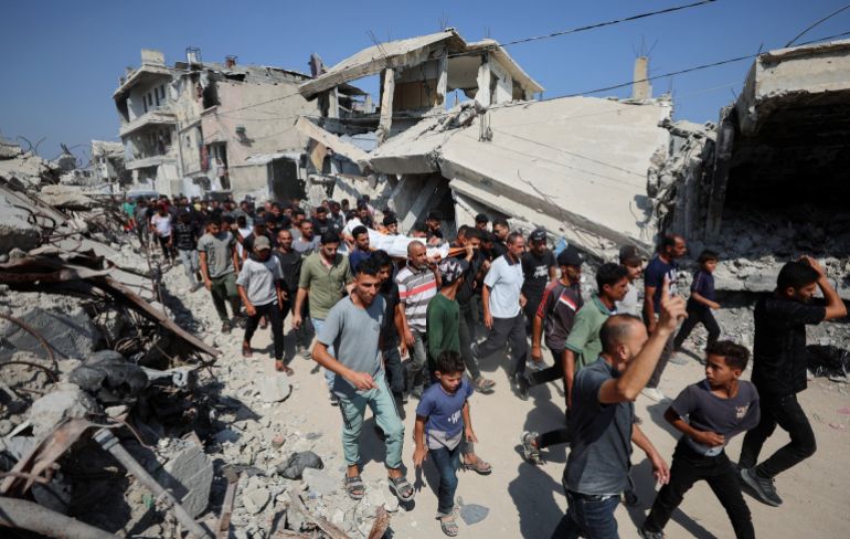 reuters_6a5a20b4-1784291508-2 SENSITIVE MATERIAL. THIS IMAGE MAY OFFEND OR DISTURB Mourners react while carrying a body during the funeral of three Palestinians, who were killed in an Israeli strike, according to medics, in Gaza City, July 16, 2026. REUTERS/Dawoud Abu Alkas