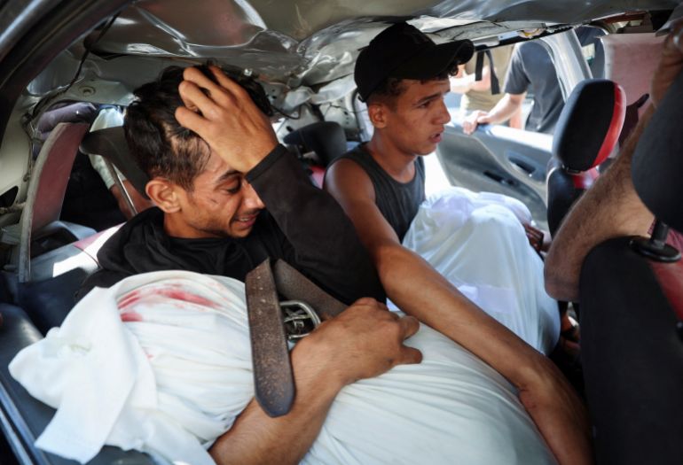 reuters_6a5d178b-1784485771 Palestinian man, Hamas Al-Hdabi, mourns holding the body of his father, Sohail, who was killed in an Israeli strike, as Hamas sits inside a car during the funeral, in Gaza City, July 16, 2026. REUTERS/Dawoud Abu Alkas