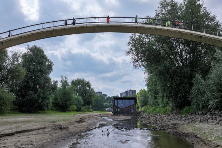 reuters_6a5d8c8f-1784515727 A drone view shows a houseboat of Het Meertje river, as the levels of the river are lower than expected for this time of the season in Nijmegen, Netherlands, July 17, 2026. REUTERS/Bart Biesemans