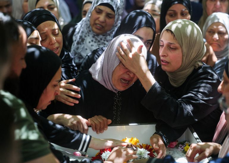 reuters_6a5fda34-1784666676 A woman mourns one of two men killed during an Israeli raid on their village, Deir Jariras, as Palestinians hold a funeral procession, in the Israeli-occupied West Bank, July 20, 2026. REUTERS/Ammar Awad TPX IMAGES OF THE DAY