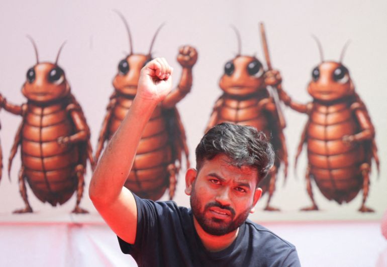 FILE PHOTO: Abhijeet Dipke, head of the Cockroach Janta Party (CJP), gestures to the supporters of the CJP during a sit-in protest demanding the resignation of Indian Education Minister Dharmendra Pradhan, in New Delhi, India, June 20, 2026. REUTERS/Anushree Fadnavis/File Photo