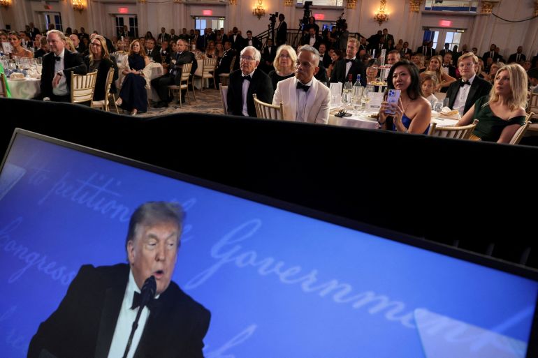 Attendees listen as U.S. President Donald Trump delivers remarks at the White House Correspondents' Association (WHCA) Dinner, which was rescheduled from April after it was interrupted when a man tried to force his way through security and fired a shotgun, at the Waldorf Astoria hotel in Washington, D.C., U.S., July 24, 2026. REUTERS/Jonathan Ernst TPX IMAGES OF THE DAY