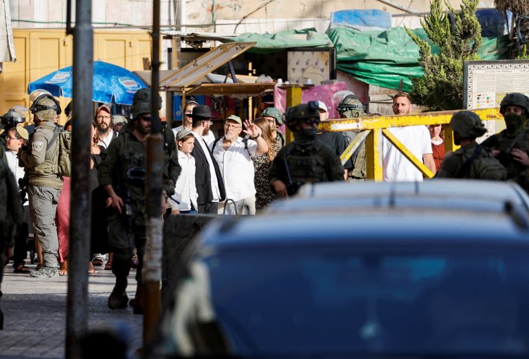 Israeli soldiers keep watch during Israeli settlers' weekly tour in Hebron, in the Israeli-occupied West Bank, July 25, 2026. REUTERS/Mussa Qawasma