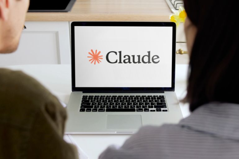shutterstock_2633673389-1777296165 Madrid, Spain; 05 28 2025 Two colleagues are researching claude, an ai large language model, on a laptop in a bright office setting