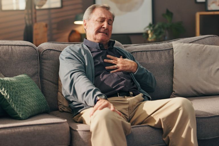 shutterstock_2646668769-1769182726 Emergency, hurt and senior man with heart attack, ache or discomfort of pressure in lounge and sore. Home, panic and elderly person with chest pain of disease, heartburn and shortness of breath; Shutterstock ID 2646668769; purchase_order: aj; job: ; client: ; other: