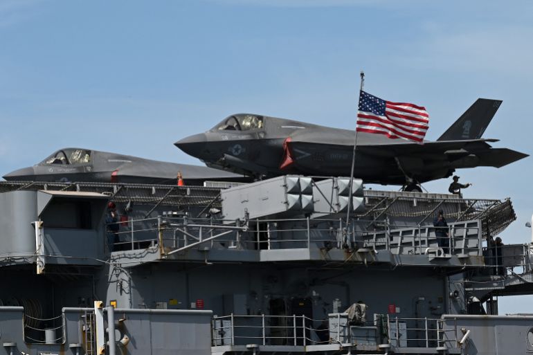 uss-tripoli2-1773650891 A pair of US Marine Corps F-35B Lightning II aircraft are seen on board the US Navys USS Tripoli (LHA-7) amphibious assault ship during a port call at the Port Area in Manila on September 27, 2022. (Photo by JAM STA ROSA / AFP)