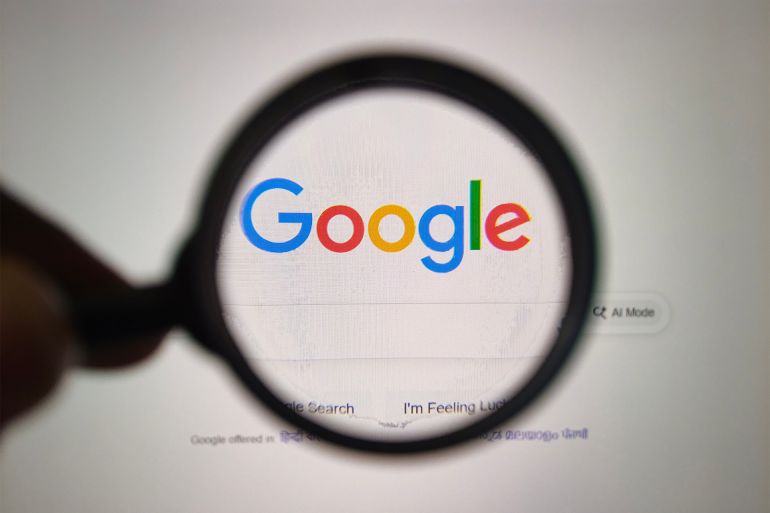 yug76gy-1769835149 A close-up view of a magnifying glass held over the iconic Google logo displayed on a computer monitor, highlighting the power of search. Captured on 05-Sep-25