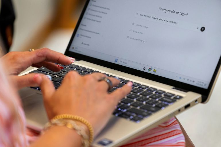 1ai-1787740057 4 of 5 | Preschool teacher Melissa Mowbray works with Al on her laptop at Academic Magnet High School during the Charleston County School District Charleston Educator Symposium Wednesday, July 22, 2026 in North Charleston, S.C. (AP Photo/Mic Smith)