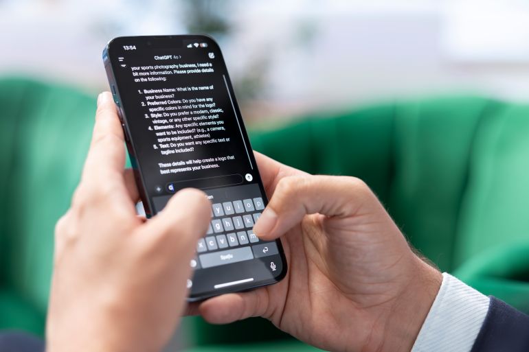 Bucharest, Romania - July 30th 2024 - Man typing prompts into an AI powered chat on his smartphone app, advanced virtual assistant showcases smart solutions for task completion. freepik