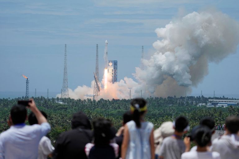 202-space-rocket-1787248474 People watch as a Long March 10B carrier rocket takes off from Wenchang Spacecraft Launch Site, before returning vertically to an offshore platform for a controlled recovery, in Hainan province, China July 10, 2026. China Daily via REUTERS ATTENTION EDITORS - THIS PICTURE WAS PROVIDED BY A THIRD PARTY. CHINA OUT. NO COMMERCIAL OR EDITORIAL SALES IN CHINA.
