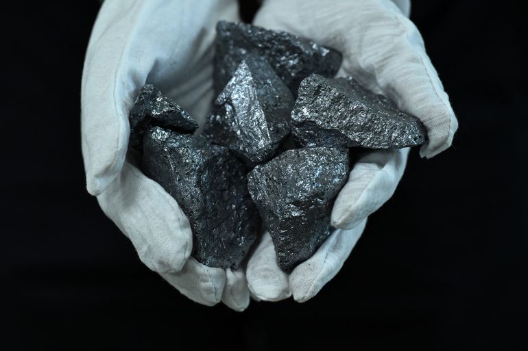 This photograph taken on July 9, 2026 shows a staff holding silica stones at Sterlite Technologies Limited (STL) manufacturing facility in Maharashtra's Chhatrapati Sambhaji Nagar. At a bustling factory in western India, technicians work around the clock to turn glass into hair-thin fibre-optic strands destined for data centres powering the global artificial intelligence boom. Sterlite earlier this year announced a $1.1-billion multi-year order from a US hyperscaler -- a term meaning a large-scale cloud service provider -- helping drive its shares up 400 percent this year.