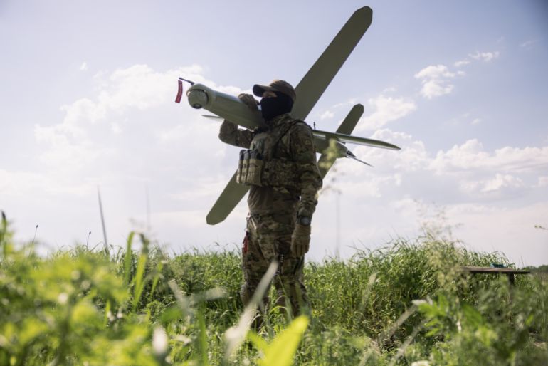 3drone-1781943981 KHARKIV REGION, UKRAINE - MAY 22: (EDITOR'S NOTE: Image has been reviewed by Ukrainian military officials prior to transmission) Members of the Lava Unmanned Systems Regiment, Norman, poses for a photograph with a Bulava strike drone, a kamikaze UAV capable of carrying a 3.5-kilogram payload with a range of up to 100 kilometres, on May 22, 2026 in Kharkiv region, Ukraine. The Lava Unmanned Systems Regiment, part of the 2nd Khartiia Corps of the Ukrainian National Guard, is a specialized unit focused on combat operations using drones and robotic systems, including deep reconnaissance and precision strikes behind enemy lines. Originally formed as a battalion in 2025, the unit was expanded into a regiment in 2026 as Ukraine increasingly relies on unmanned technologies in warfare. (Photo by Diego Fedele/Getty Images)