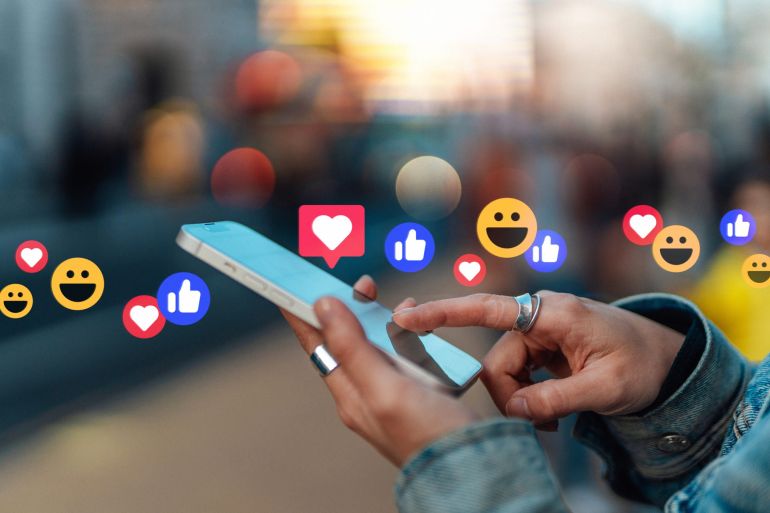 46846843-1777361276 Close-up of female hand touching screen, giving likes and commenting on social media platform with smartphone. Lifestyle and technology.