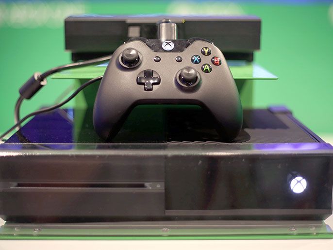 583dd585-e88b-4e10-ad57-c401eb677532 epa03833265 View of the new Xbox One and a gamepad on display at the Microsoft booth at the Gamescom 2013 trade fair for computer and video games in Cologne, Germany, 22 August 2013.