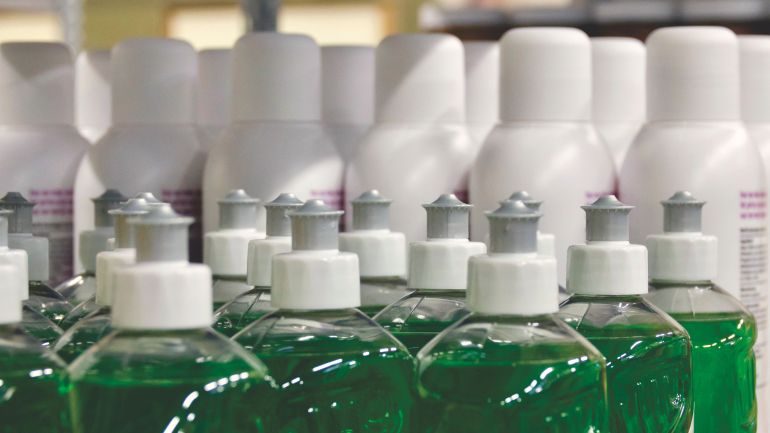 592670-1786115048 Close-up view of green liquid in bottles, ideal for household cleaning and stocks.