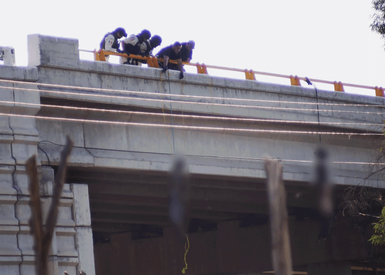 6546-1786305780 Mexico Violence EDS NOTE: GRAPHIC CONTENT - Agents remove bodies hanging from a bridge in Cuauhtemoc City, Mexico, Thursday, Nov. 18, 2021. Mexican authorities discovered 10 bodies Thursday, nine of them hanging from an overpass, in the central Mexican state of Zacatecas, the scene of a battle for territory among drug cartels. (AP Photo/Edgar Robledo)