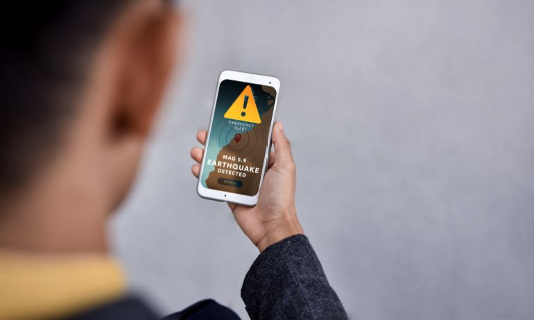 aaa-1-1785839527 Earthquake Warning Alert on Mobile Phone Smartphone, Climate change, Technology for safety, emergency, disaster prevention, and environmental protection through real-time information Adobe Stock