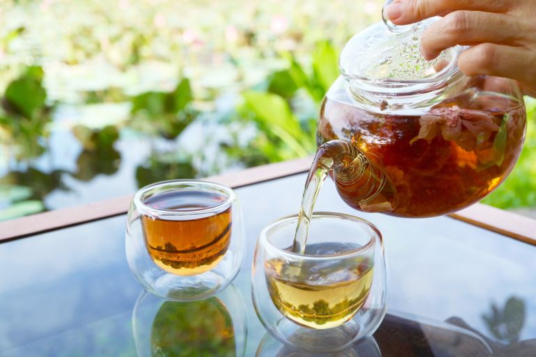 adobestock_642017035-1787838437 Closeup of hot rose tea being poured in a cup with blurry water lily pond in the backdrop المصدر: أدوبي ستوك