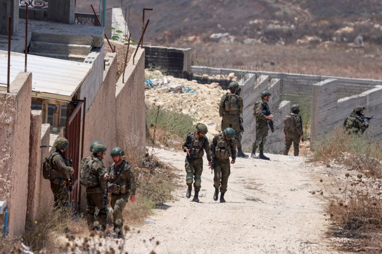 afp_6a64d13bdb89-1784992059 Israeli soldiers patrol the road in the Palestinian village of Tell, in the Israeli-occupied West Bank on July 25, 2026, a day after four Palestinians and two Israelis died in local clashes in the village.