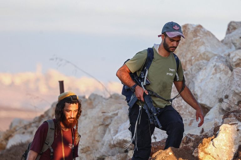 afp_6a6c83ee938a-1785496558 Israeli settlers take part in a march between the villages of Sarra and Tell, southwest of Nablus in the occupied West Bank on July 31, 2026.