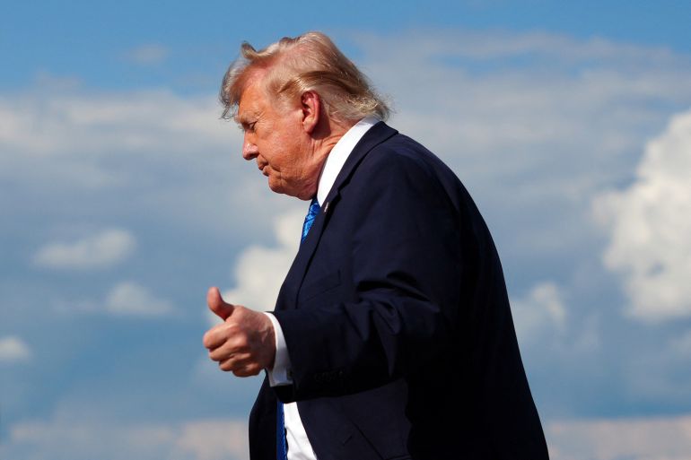 US President Donald Trump flashes a thumbs up while stepping off Air Force One upon arrival at Morristown Municipal Airport in Morristown, New Jersey, on July 31, 2026.
