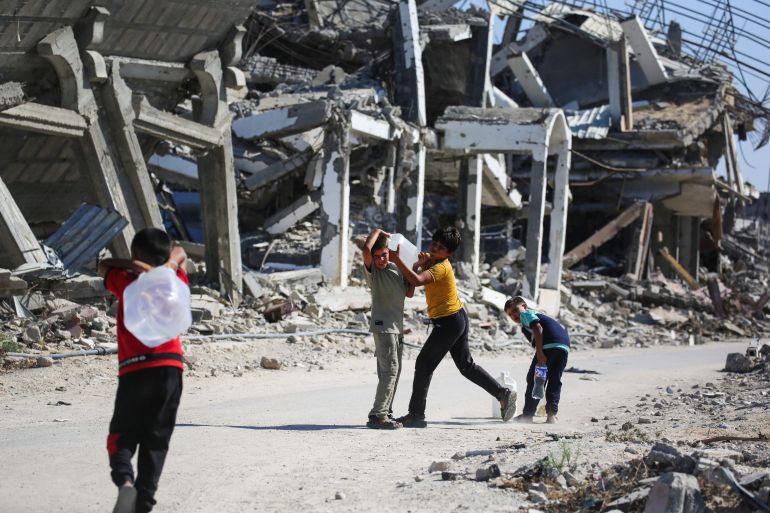afp_6a6e86ff2e8e-1785628415 Palestinian children play amid the ruins of destroyed buildings in Khan Yunis in the southern Gaza Strip on July 31, 2026.