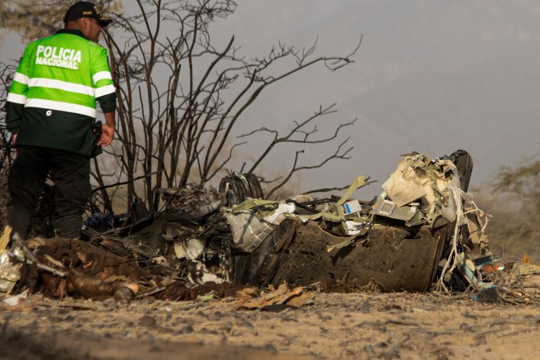 afp_6a6ea65fd4d0-1785636447 A police officer stands alongside the wreckage of the small plane involved in a fatal accident that claimed the lives of its 13 occupants in the Vista Alegre district, Nazca, Peru, on August 1, 2026.