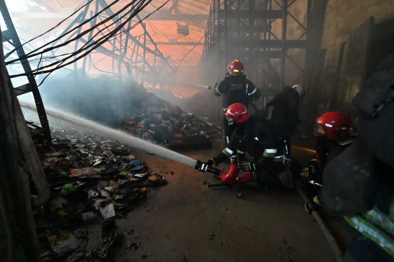 afp_6a6f0d5aa598-1785662810 Firefighters put out a fire in a damaged book store area following a Russian air attack in Kharkiv on August 1, 2026, amid the Russian invasion of Ukraine. (Photo by SERGEY BOBOK / AFP)