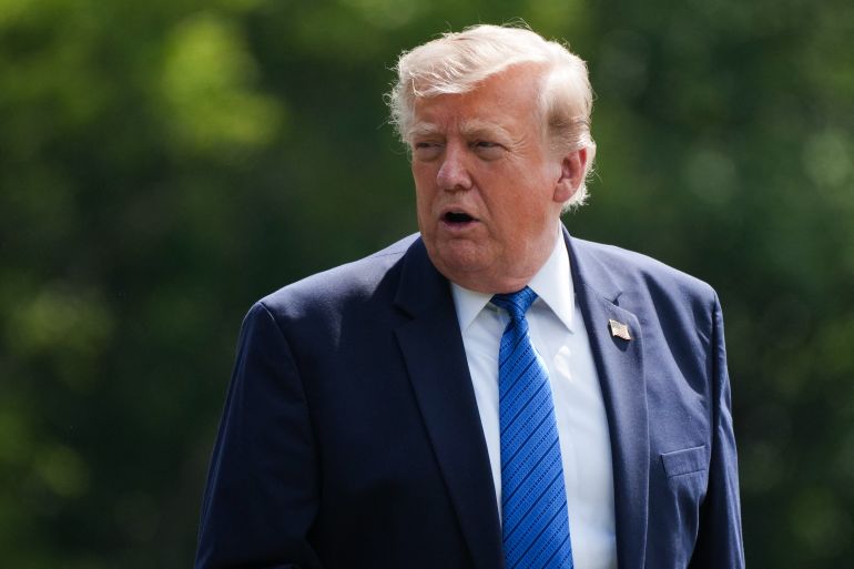 US President Donald Trump gestures before boarding Marine One as he departs Camp David in Maryland, on July 31, 2026, following a Cabinet meeting.
