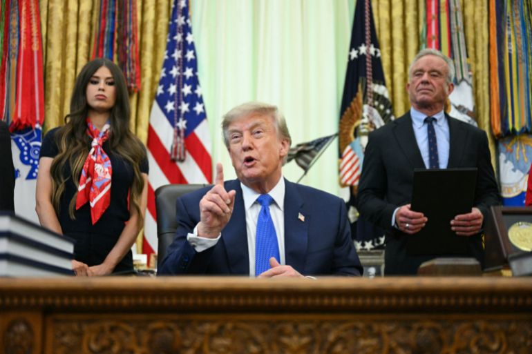 afp_6a7a3271bfaa-1786393201 US President Donald Trump speaks after signing an executive order calling for more research and flexibility on vaccines, alongside US Secretary of Health and Human Services Robert F. Kennedy Jr. (R) and Jayme Leagh Franklin (L), founder of The Conservateur, in the Oval Office of the White House in Washington, DC, on August 10, 2026.