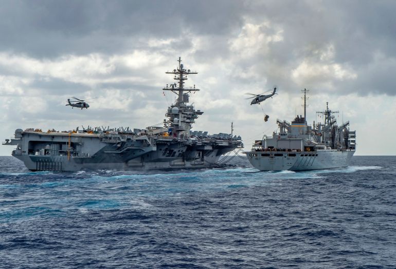 afp_6a7fa919a063-1786751257-1 (FILES) This handout picture released by the US Navy on May 8, 2019 shows the Nimitz-class aircraft carrier USS Abraham Lincoln (CVN 72) while conducting a replenishment-at-sea with the fast combat support ship USNS Arctic (T-AOE 9), while MH-60S Sea Hawk helicopters assigned to the "Nightdippers" of Helicopter Maritime Strike Squadron (HSM) 5, transfer stores between the ships.