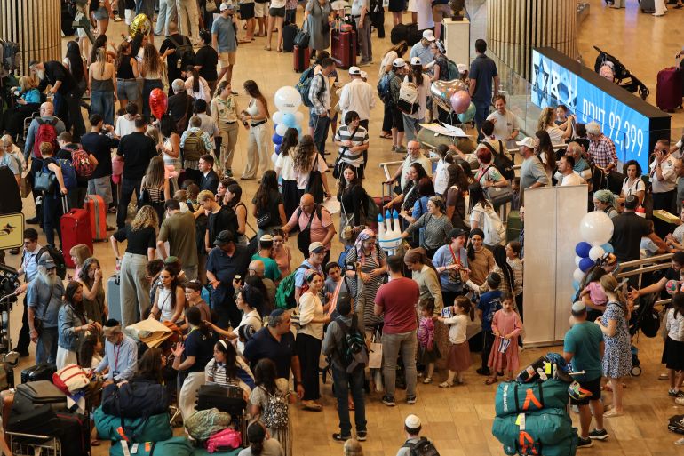 afp_6a8835e9e1e7-1787311593 Passengers wait with their luggage amid disruptions caused by a surprise staff strike at Ben Gurion Airport in Lod, near Tel Aviv, on August 20, 2026.
