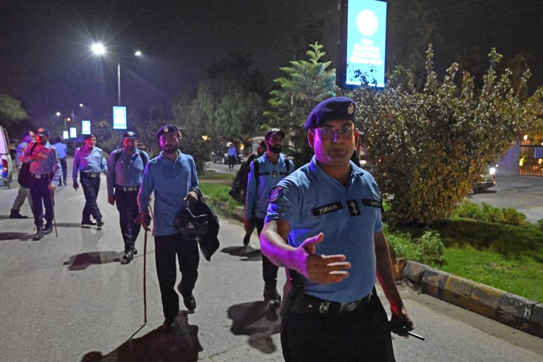 Security personnel clear the road as they cordon off a street outside the Shifa International Hospital in Islamabad on August 20, 2026 after Pakistan's Supreme Court ordered to transfer jailed former prime minister Imran Khan to hospital for medical treatment.