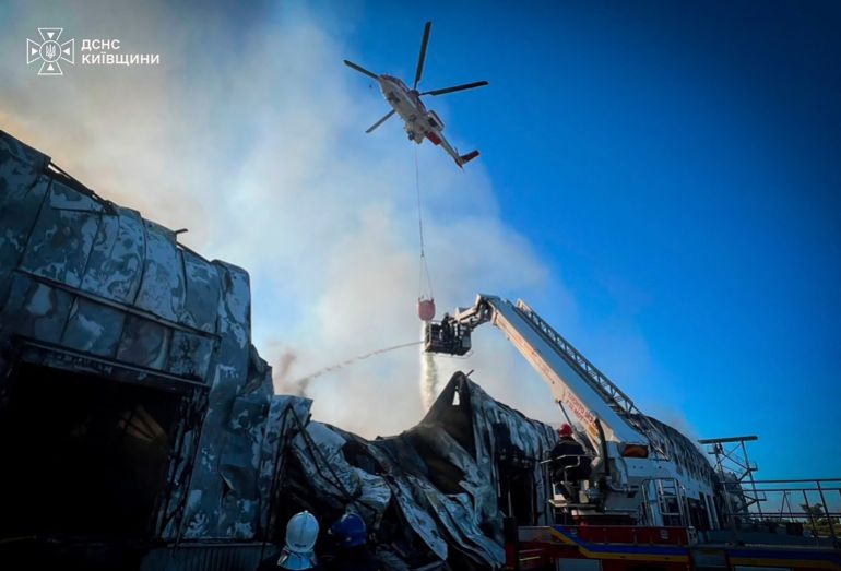 afp_6a889a0132ee-1787337217 In this handout photograph taken and released by the Ukrainian Emergency Service on August 20, 2026, Ukrainian rescuers work to extinguish a fire in a warehouse following an air attack at an undisclosed location in the Kyiv region, amid the Russian invasion of Ukraine.