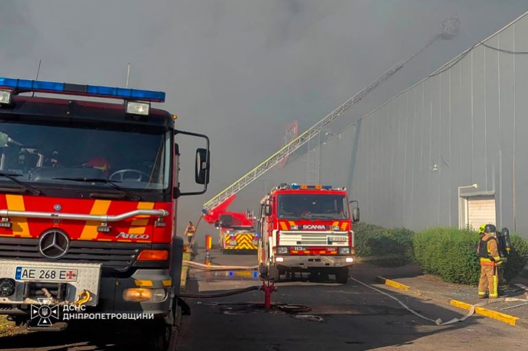 afp_6a889a195214-1787337241 This handout photograph taken and released by the Ukrainian State Emergency Service on August 21, 2026 shows firefighters taking part in operations against a fire at the site of a shopping mall damaged following a Russian strike in Kryvyi Rih amid the Russian invasion of Ukraine.