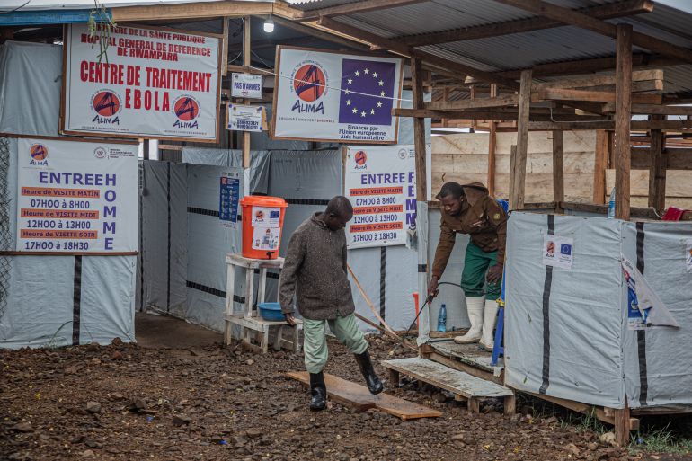 (FILES) A hygiene worker disinfects a person's feet at the entrance to the Rwampara Ebola Treatment Centre (ETC) in Bunia, Ituri, in the east of the Democratic Republic of Congo on July 13, 2026.